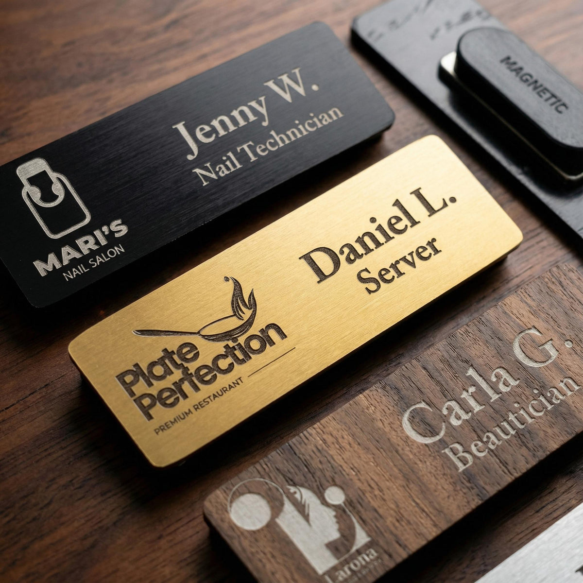 Engraved magnetic name badges in black, gold and walnut