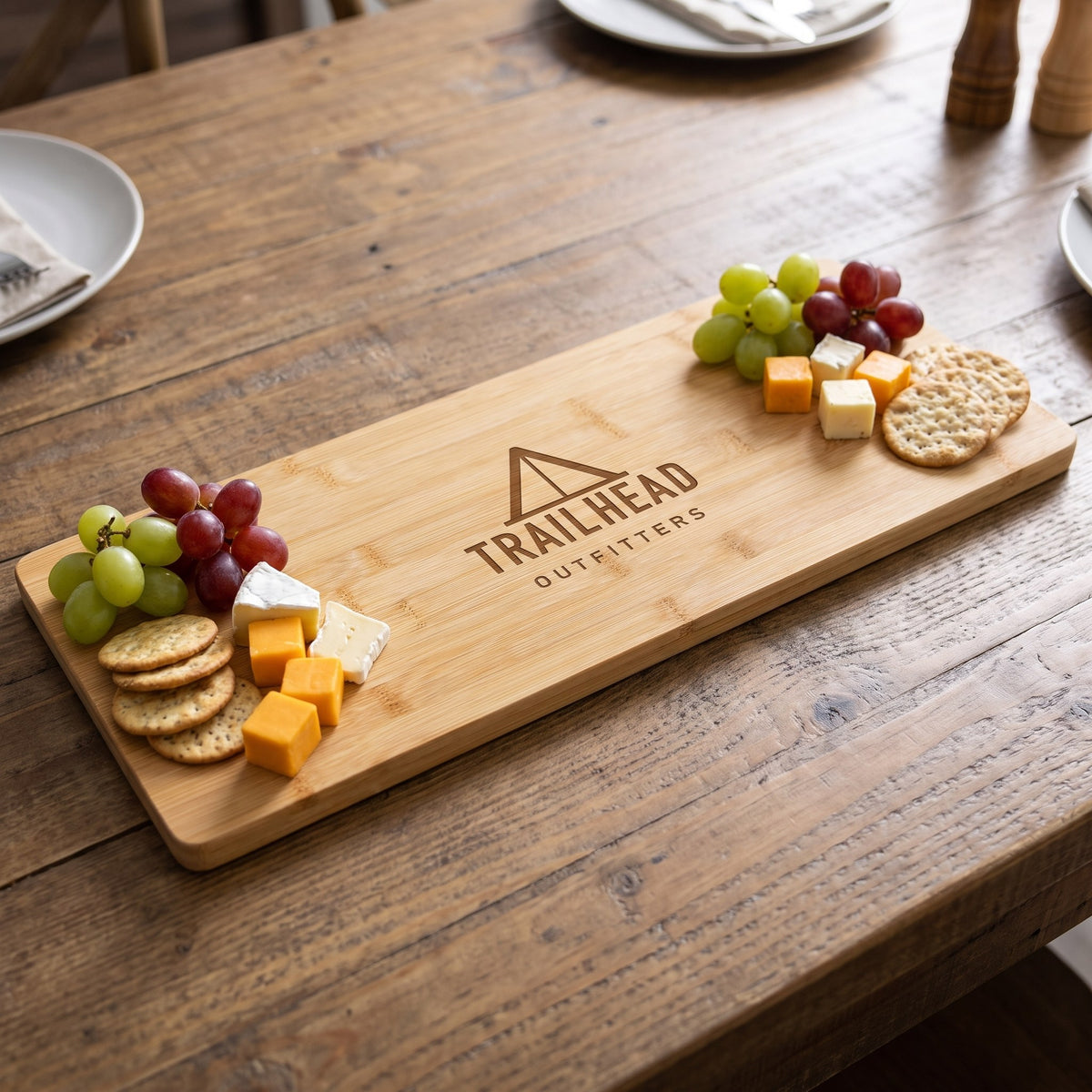 Custom Logo Bamboo Charcuterie Board 19¾" x 8" – with grapes and cheese with sample engraved logo