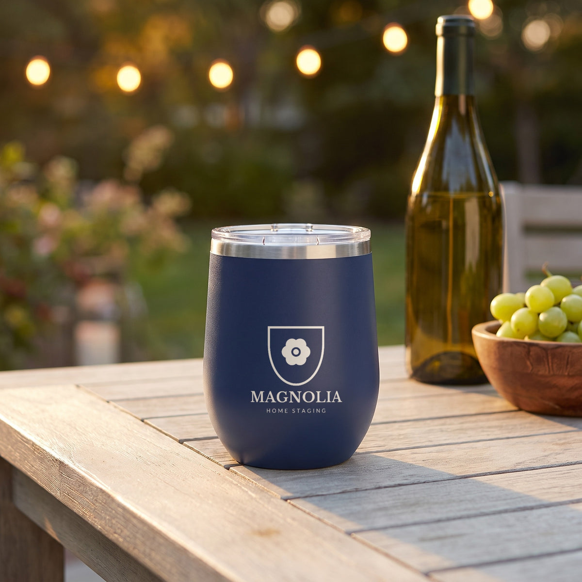 Custom Logo Polar Camel 12 oz Stemless Wine Tumbler, navy with an engraved sample logo on a patio table