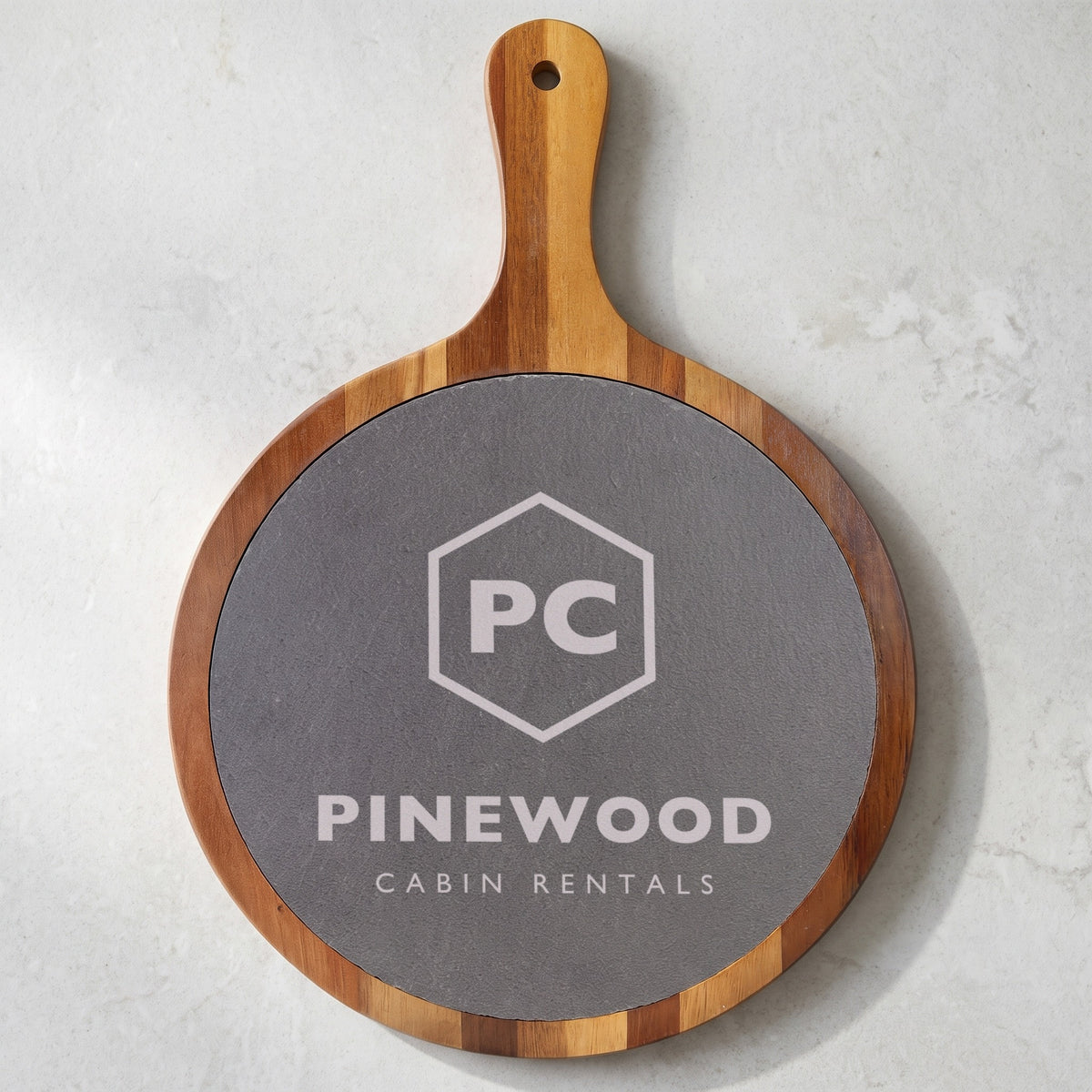 Custom Logo Round Slate & Acacia Serving Board with Handle, 10 1/2 inch board with an engraved sample logo on the round slate