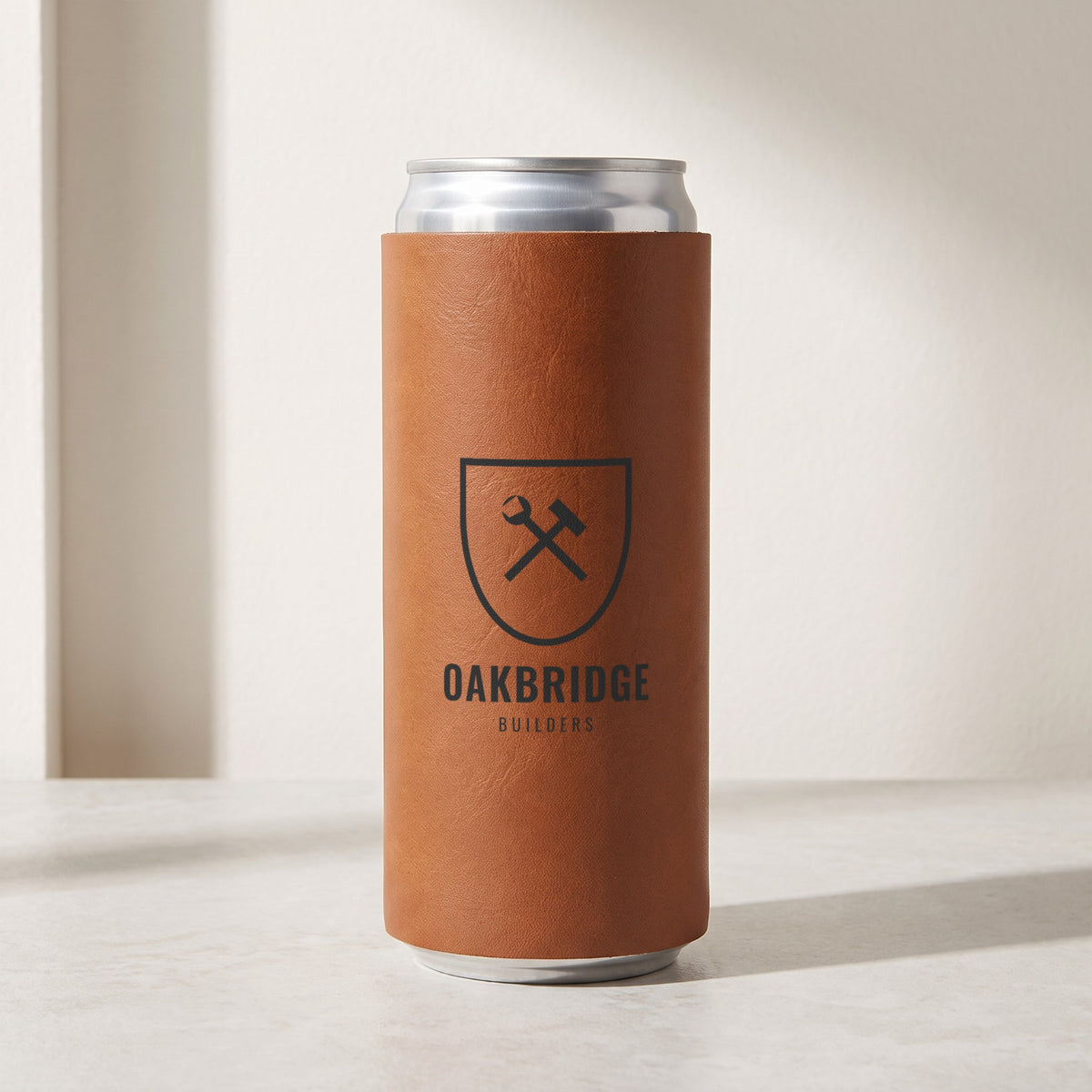 Custom Logo Leatherette Slim Can Coolers, rawhide slim can cooler with an engraved sample logo on a slim 12 oz can