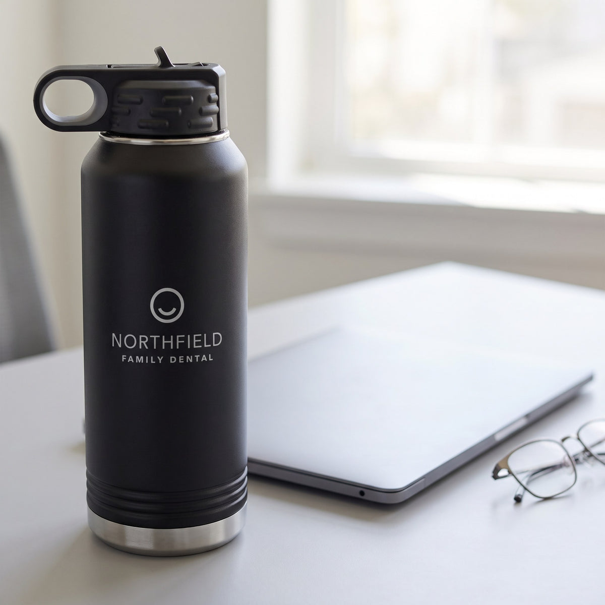 Custom Logo Polar Camel 32 oz Water Bottle – Black on an office desk with sample engraved logo