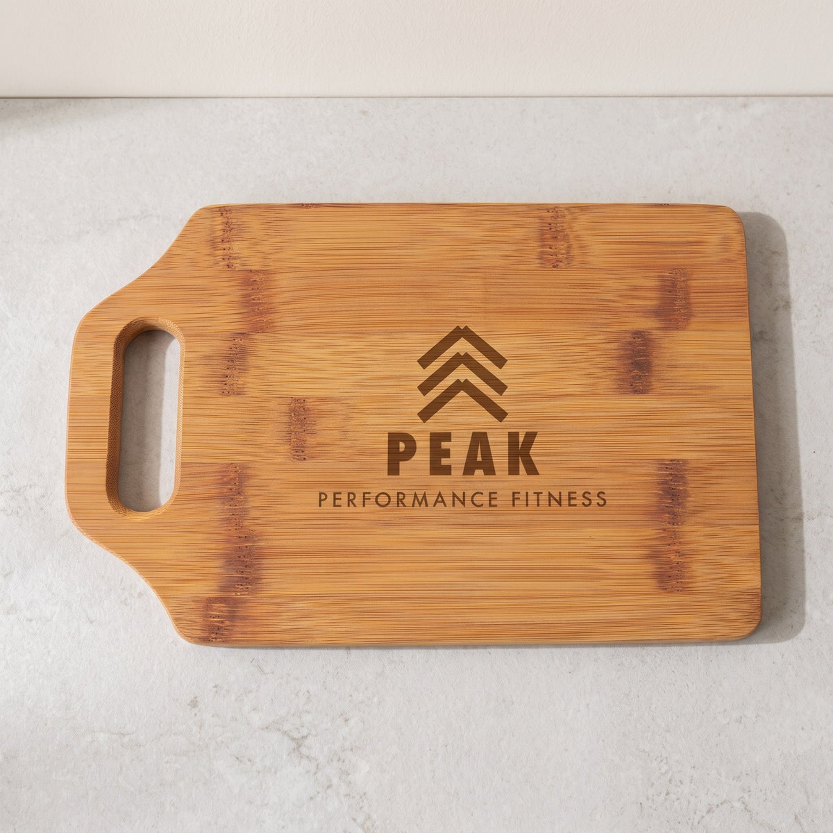 Custom Logo Bamboo Cutting Boards with Handle – 9" x 6" with sample engraved logo