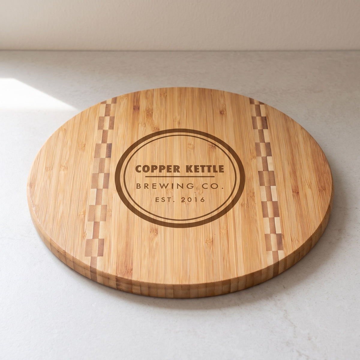 Custom Logo Bamboo Cutting Boards with Butcher Block Inlay – 11¾" round with sample engraved logo