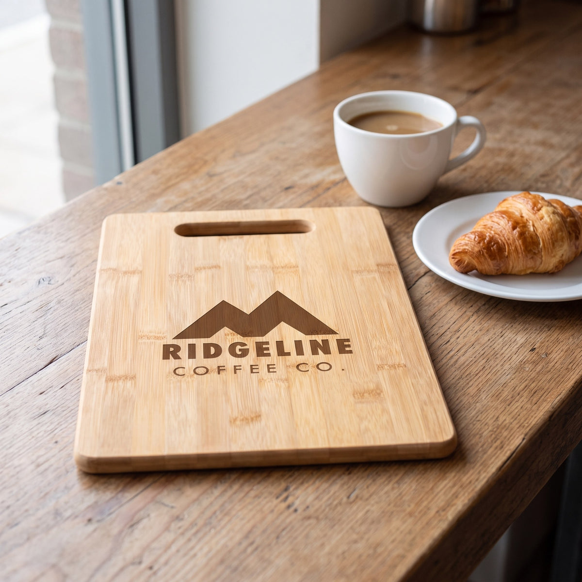 Custom Logo Bamboo Rectangle Cutting Boards – on a cafe counter with sample engraved logo