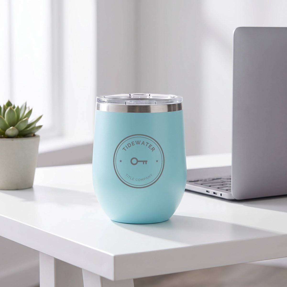 Custom Logo Polar Camel 12 oz Stemless Wine Tumbler, light blue with an engraved sample logo on an office desk