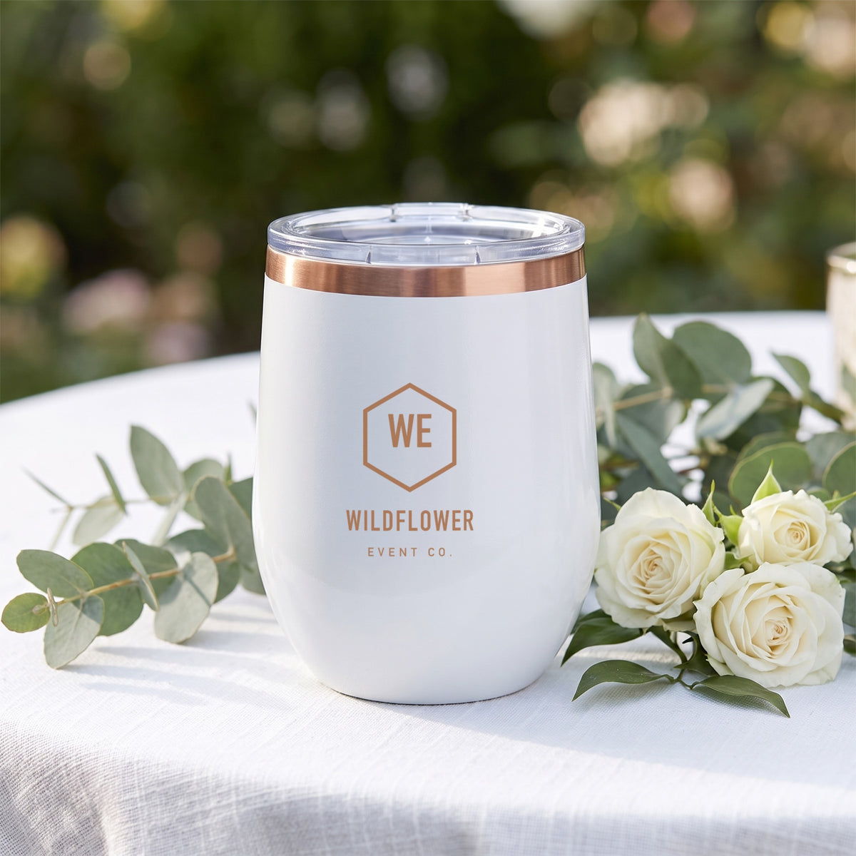 Custom Logo Polar Camel 12 oz Stemless Wine Tumbler, white with a rose gold rim and a rose gold engraved sample logo at a wedding
