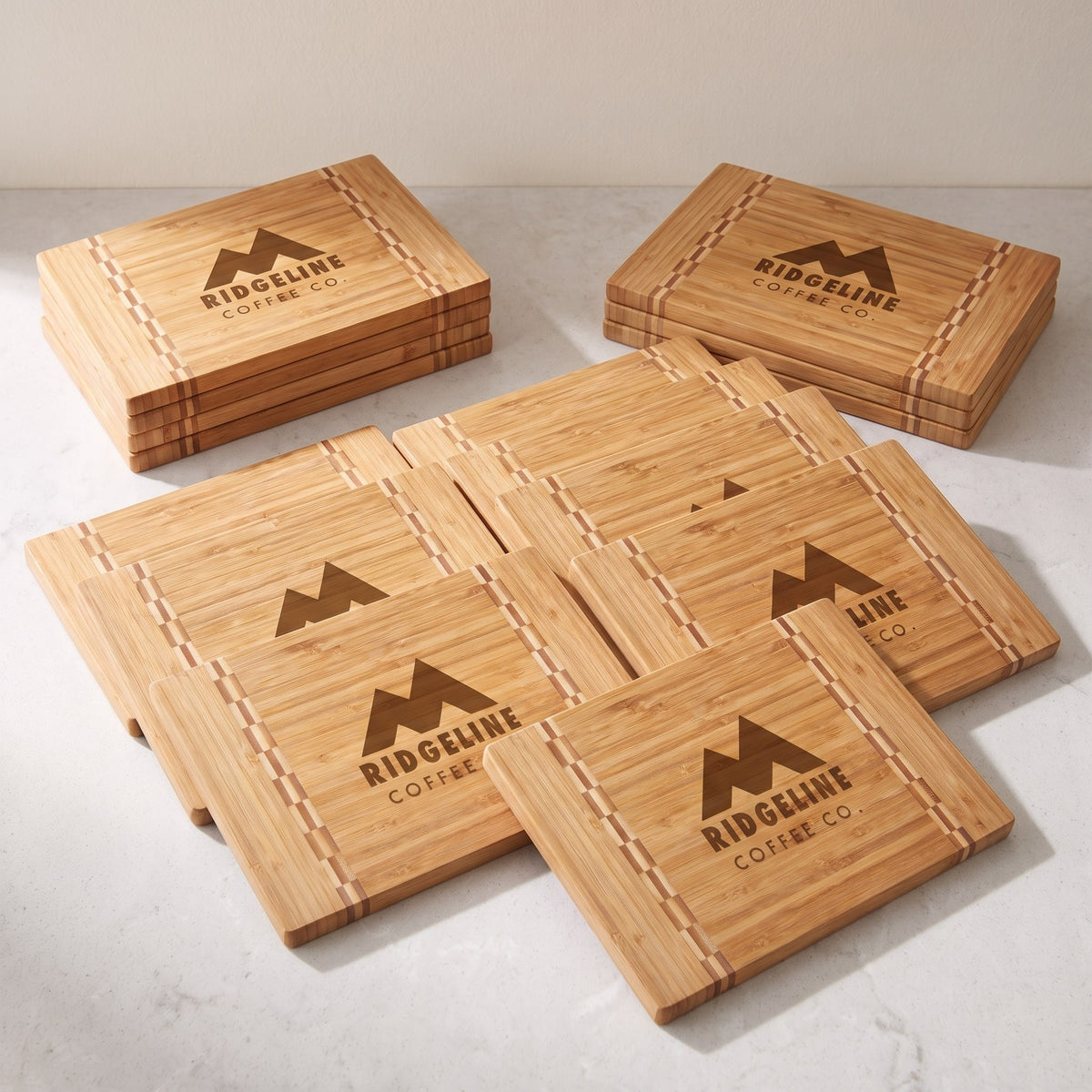 Custom Logo Bamboo Boards with Butcher Block Inlay – bulk order of bamboo boards with butcher block inlay, all engraved with the same sample logo