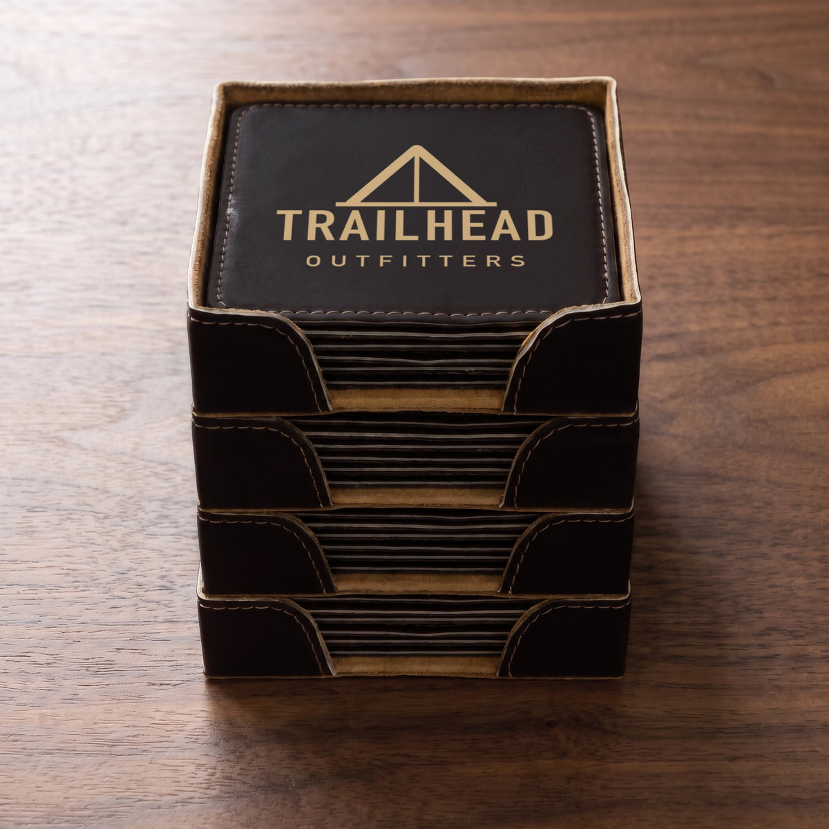 Custom Logo Leatherette Coaster Set – bulk order: a stack of square Black/Gold sets, gold engraved sample logo on the top coaster