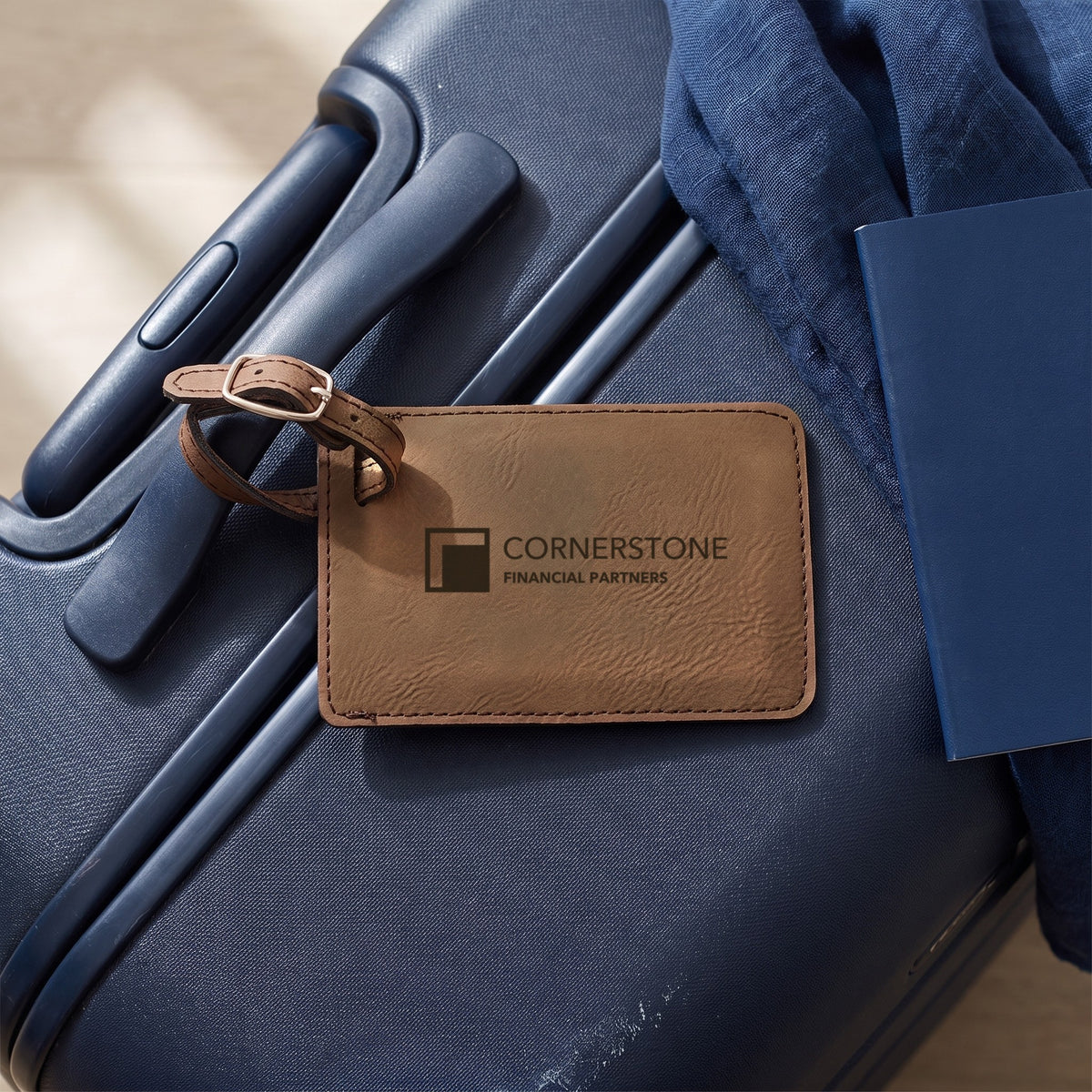 Custom Logo Leatherette Luggage Tag – Dark Brown on a carry-on suitcase, engraved sample logo