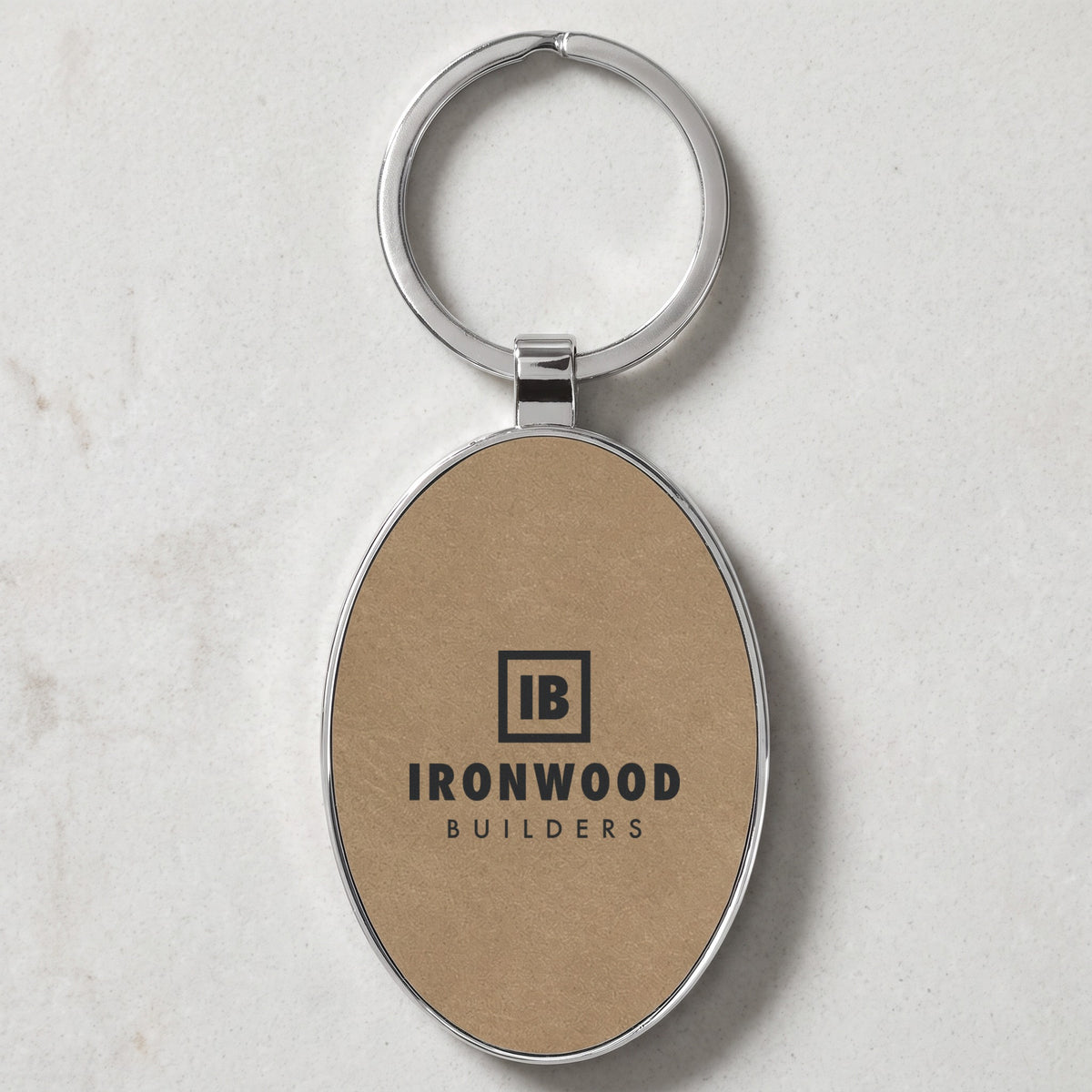 Custom Logo Leatherette & Metal Keychain – Oval, Light Brown with an engraved sample logo