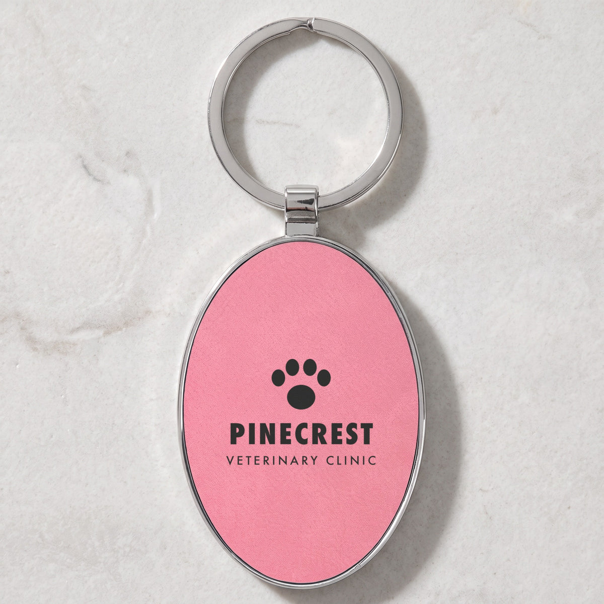 Custom Logo Leatherette & Metal Keychain – Oval, Pink with an engraved sample logo