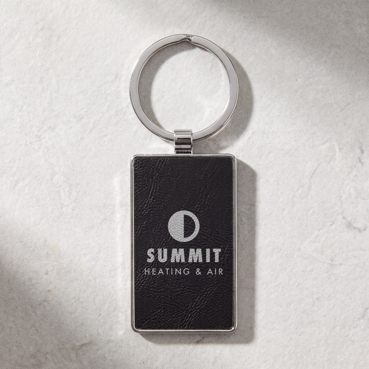 Custom Logo Leatherette & Metal Keychain – Rectangle, Black/Silver with an engraved sample logo