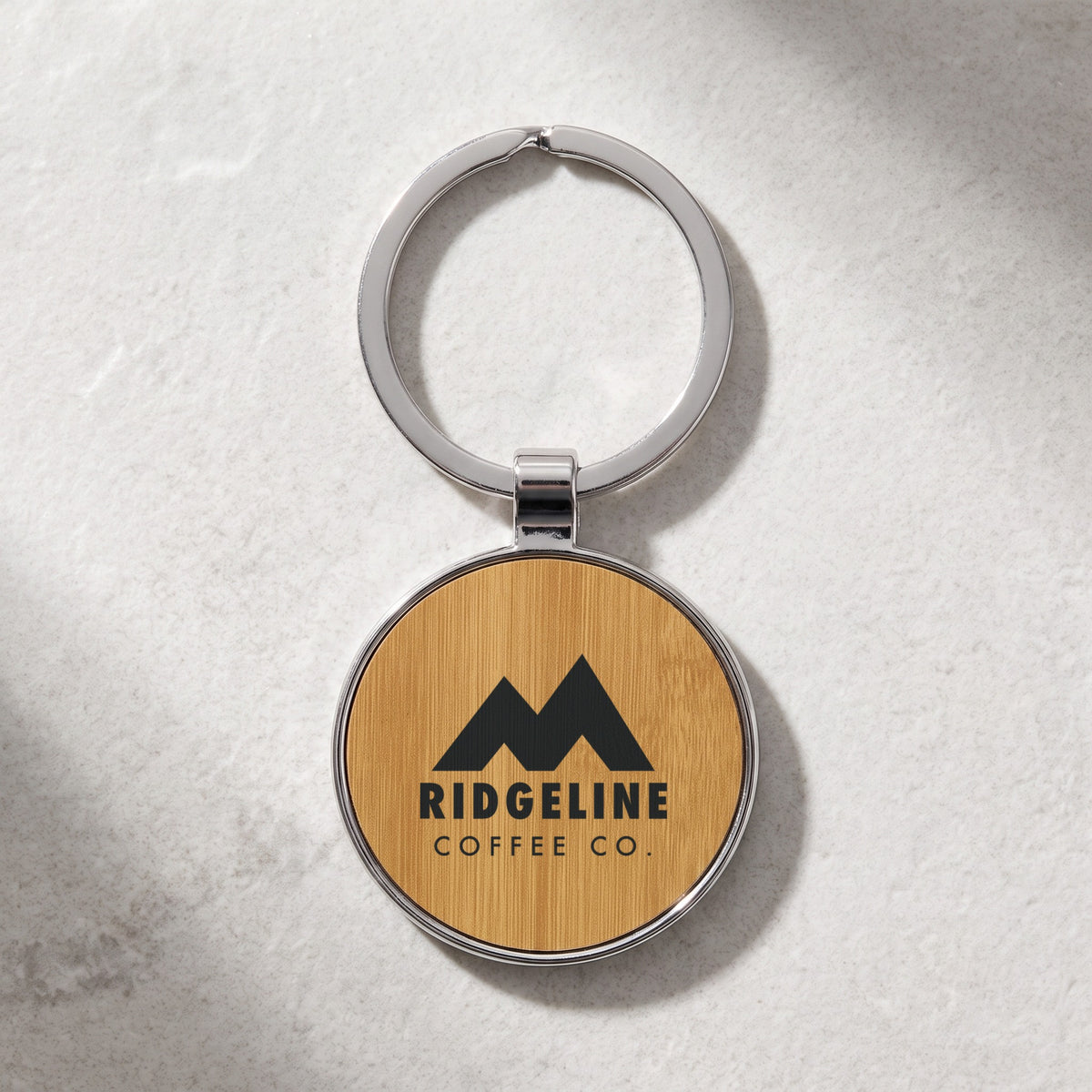 Custom Logo Leatherette & Metal Keychain – Round, Bamboo with an engraved sample logo