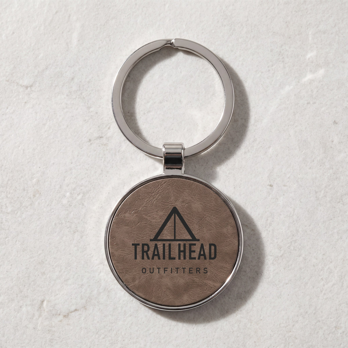 Custom Logo Leatherette & Metal Keychain – Round, Gray with an engraved sample logo
