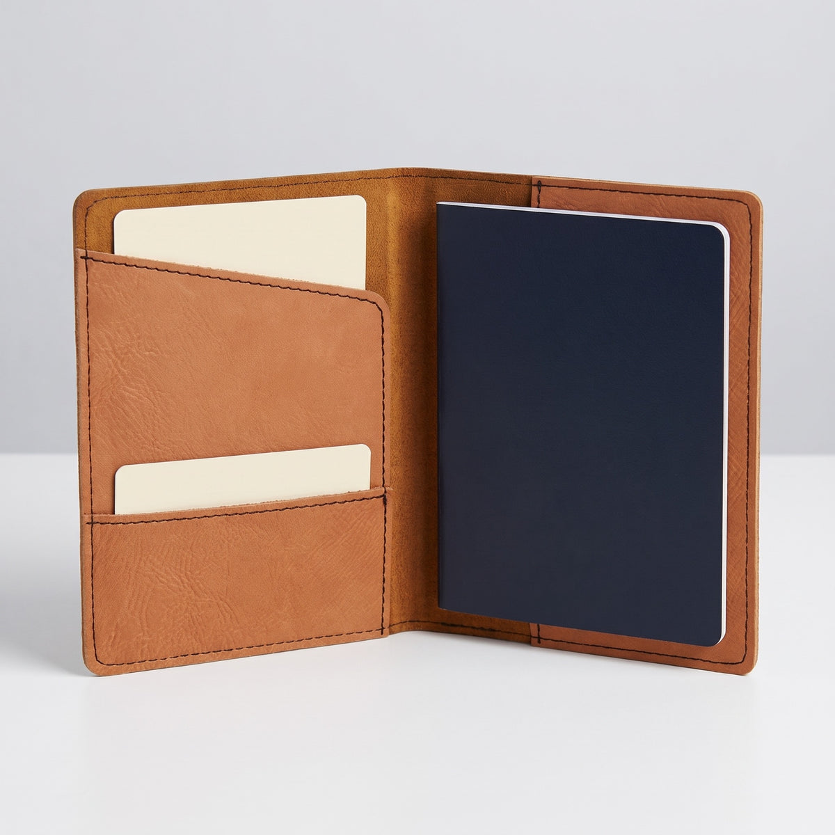 Custom Logo Leatherette Passport Holder, rawhide, standing open with a passport in the right pocket and a card in the left slot