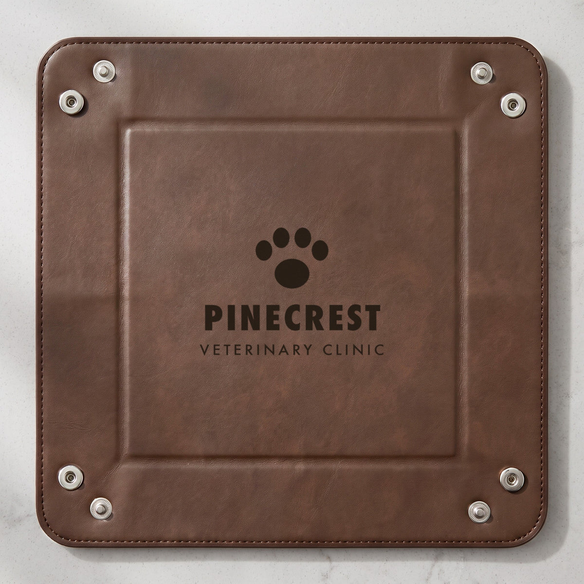 Custom Logo Leatherette Valet Tray – 6" Dark Brown unsnapped and lying flat, dark engraved sample logo