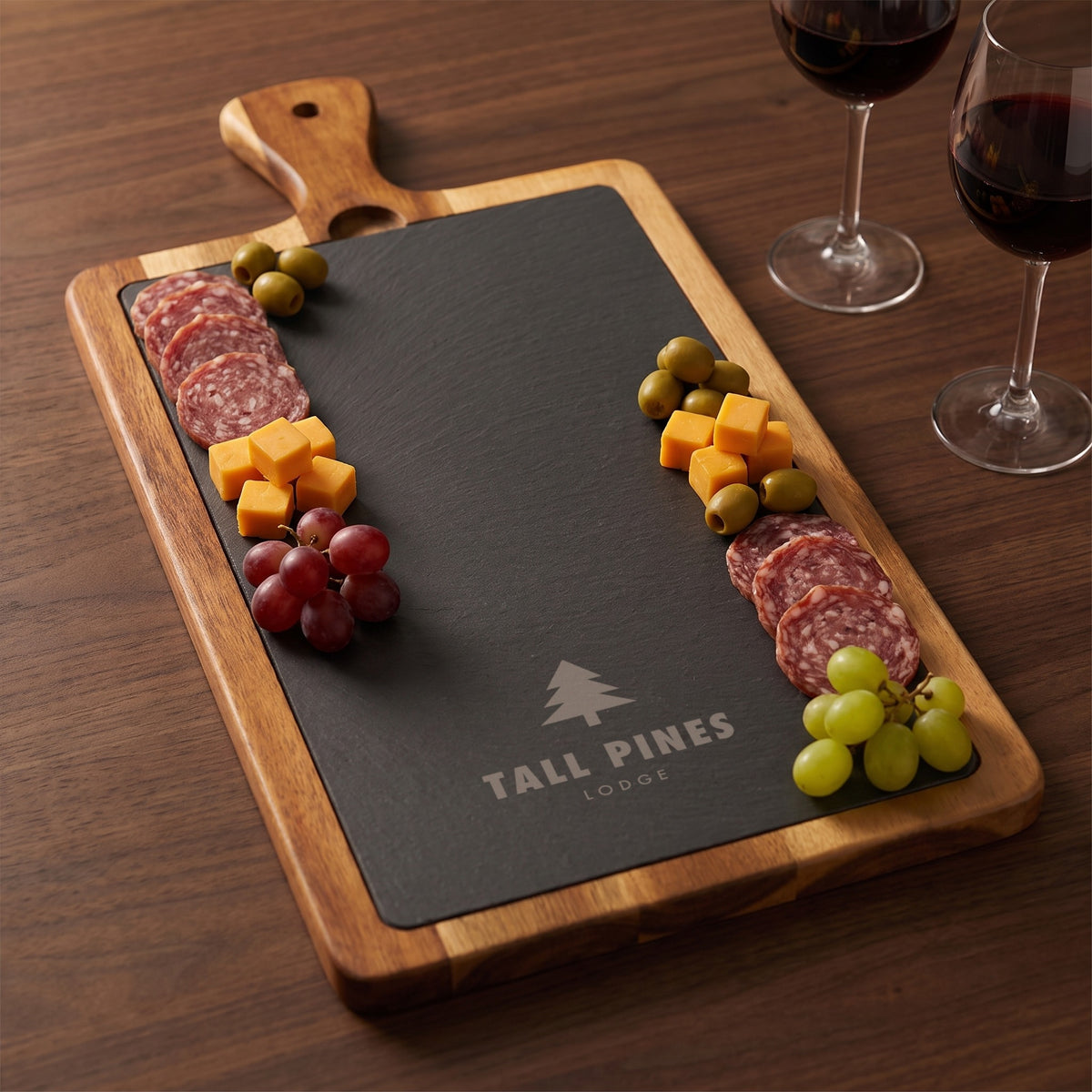 Custom Logo Slate & Acacia Paddle Cutting Board, engraved sample logo, served with salami, cheese, grapes and wine