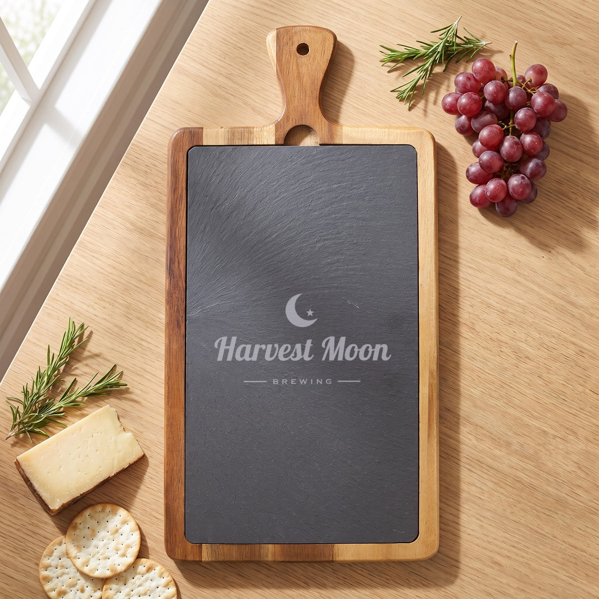 Custom Logo Slate & Acacia Paddle Cutting Board, 16 x 7 3/4 inch board with an engraved sample logo on the slate
